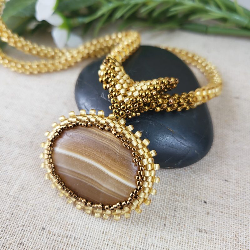 Brown banded agate oval pendant on gold seed bead rope
